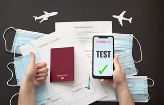 An International Certificate Of Vaccination, A Passport And Surgical Masks On A Black Background
