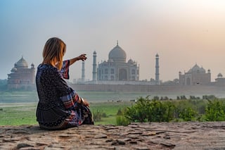 Beautiful girl points to taj mahal concept