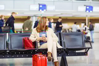 Business Woman At International Airport Sitting And Drinking Coffee In Terminal