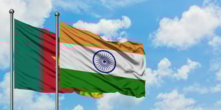 Cameroon and india flags waving together on blue cloudy sky two country relationship