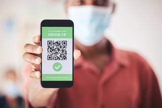 Covid QR code and phone in person hand for vaccinated digital verification certificate