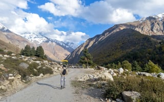 Ear View Of Solo Indian Traveler In Winter Clothing Walking Alone Hiking A Remote Mountai