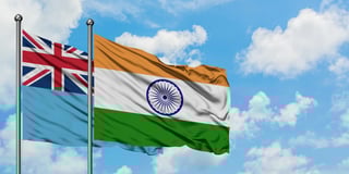 Fiji and india flag waving in the wind against white cloudy blue sky together diplomacy