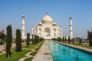 Front elevation of Taj Mahal with fountain pond in foreground in a sunny day