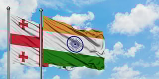 Georgia and india flag waving in the wind against white cloudy blue sky together diplomacy