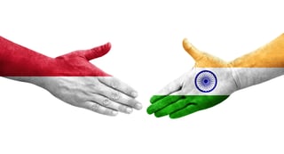 Handshake Between India And Monaco Flags Painted On Hands Isolated Transparent