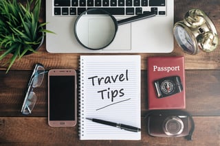 laptop notebook smartphone passport compass magnifying glass and clock with travel tips word