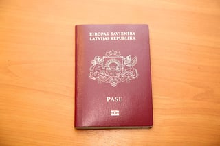 Latvian Citizen S Passport On The Table Of Red Color