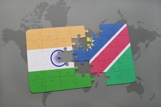 Puzzle With The National Flag Of India And Namibia On A World Map Background Macro