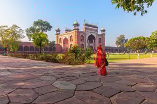 taj mahal east gate and an indian woman india agra
