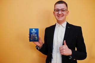 Young Handsome Man Holding Barbados Passport Id Over Yellow Background Happy And Show