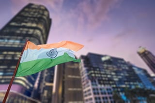 Indian national flag against city skyline