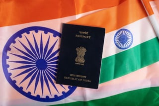 Indian passport lying on Indian flags